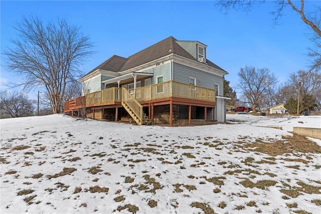 snow covered house with a deck