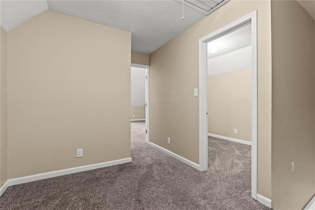 unfurnished room with carpet, lofted ceiling, and a textured ceiling