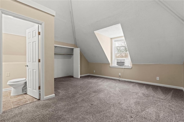 additional living space featuring cooling unit, lofted ceiling, and carpet flooring