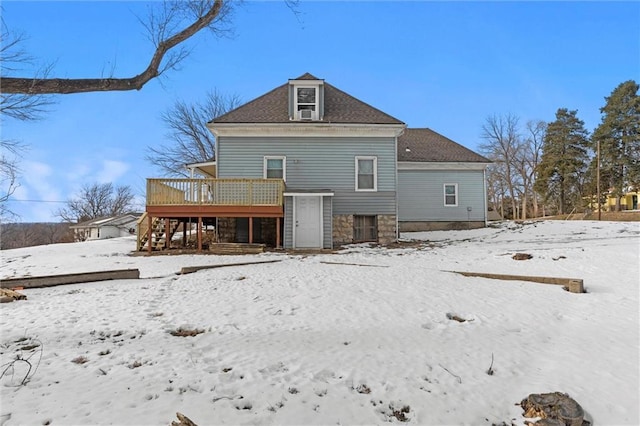 snow covered house featuring a deck