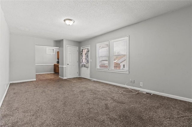 interior space with a textured ceiling and carpet