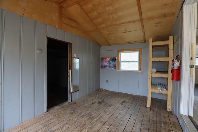 unfurnished room with lofted ceiling, wooden ceiling, and hardwood / wood-style floors