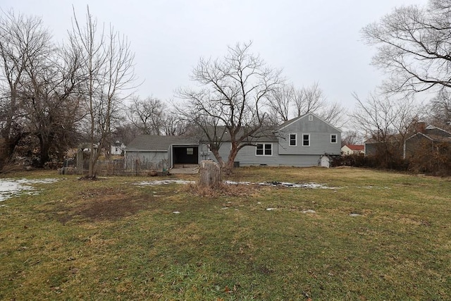 rear view of house featuring a yard