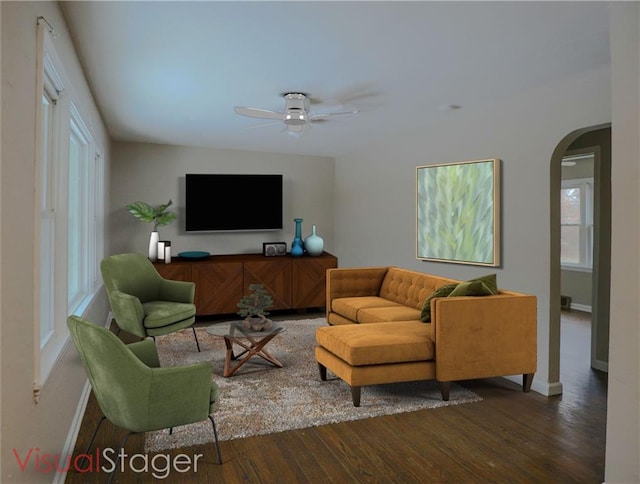 living room with arched walkways, ceiling fan, wood finished floors, and baseboards