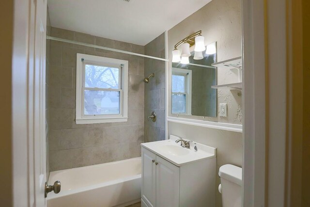 bathroom with shower / tub combination, vanity, and toilet