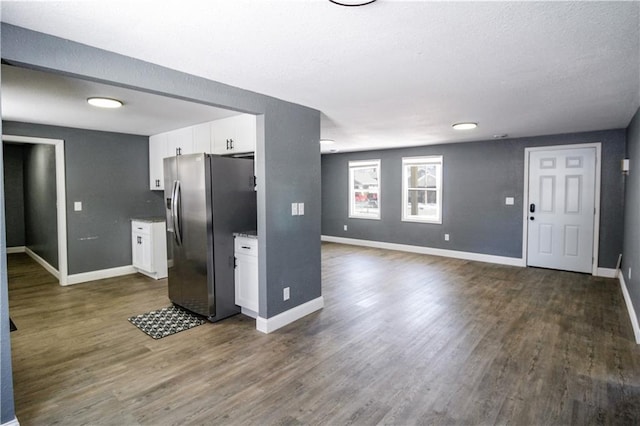 kitchen with white cabinetry, dark wood-type flooring, and stainless steel fridge with ice dispenser