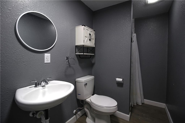 bathroom featuring sink, wood-type flooring, and toilet