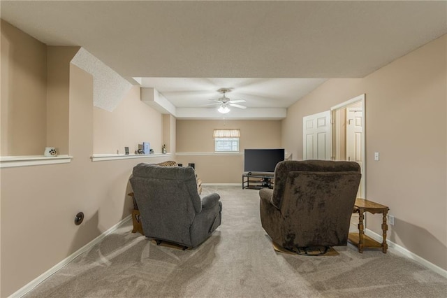 carpeted living room with ceiling fan