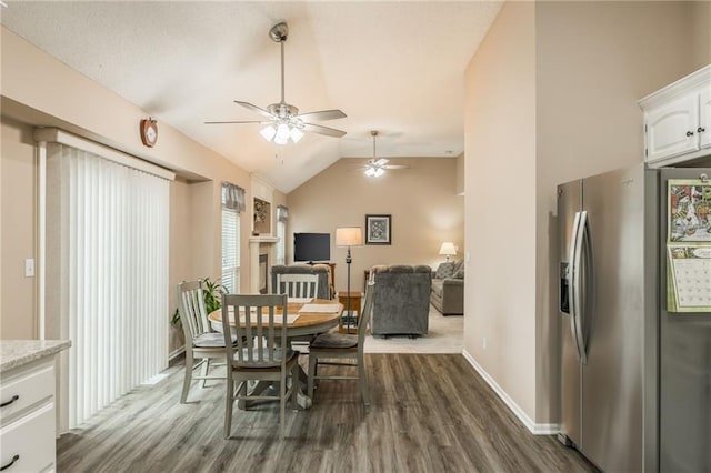 dining room with vaulted ceiling and dark hardwood / wood-style flooring