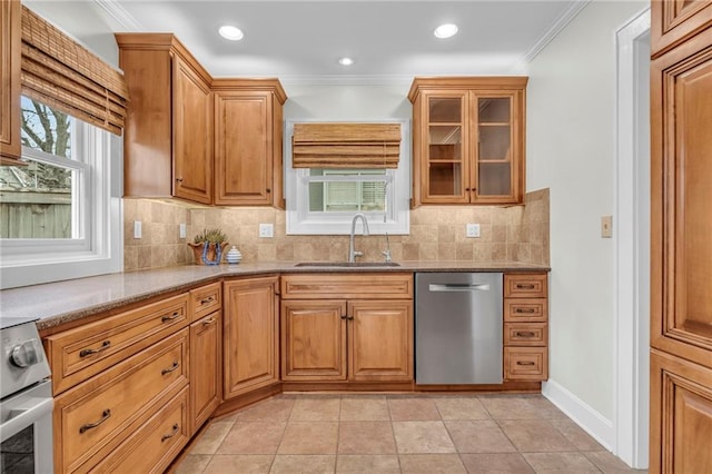 kitchen featuring light tile patterned flooring, appliances with stainless steel finishes, sink, light stone counters, and crown molding