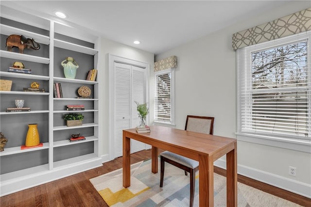 office area with hardwood / wood-style flooring and built in shelves