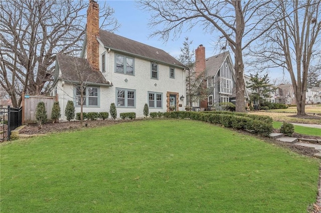 rear view of house featuring a yard