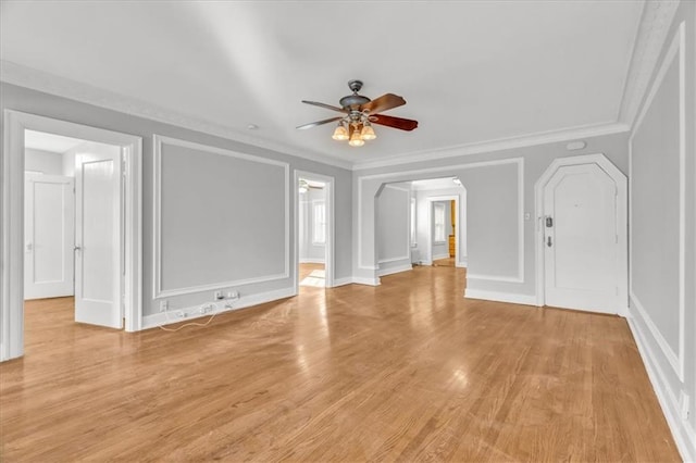 unfurnished living room with ceiling fan, ornamental molding, and light hardwood / wood-style floors