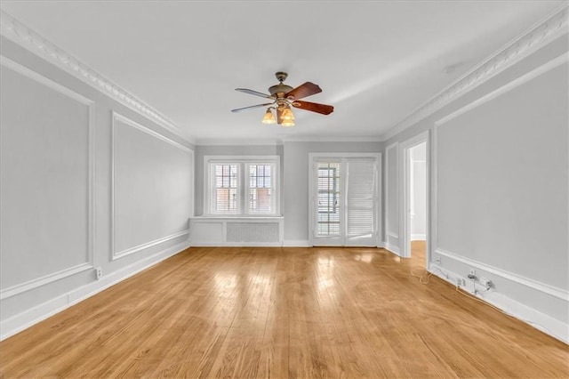 unfurnished room featuring crown molding, ceiling fan, and light hardwood / wood-style flooring