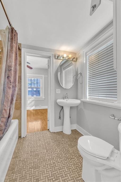 bathroom with toilet and shower / tub combo