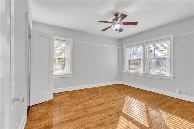 spare room featuring light hardwood / wood-style flooring and ceiling fan