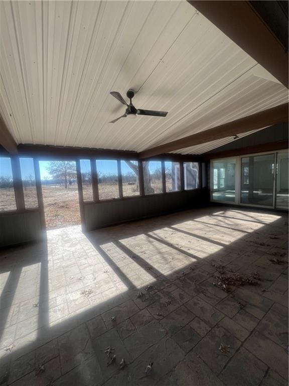 unfurnished sunroom with lofted ceiling, wooden ceiling, and ceiling fan