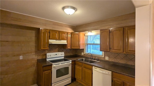 kitchen with tasteful backsplash, white appliances, and sink