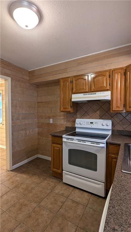 kitchen featuring sink, a textured ceiling, tile patterned flooring, decorative backsplash, and white range with electric stovetop