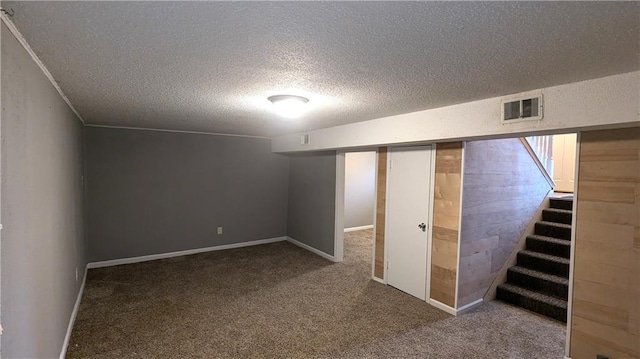 basement with carpet floors and a textured ceiling