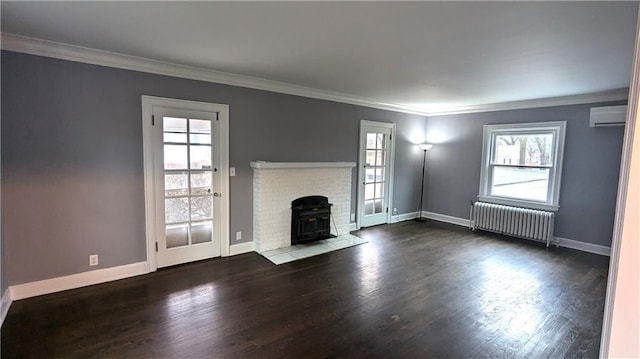 unfurnished living room with dark wood-type flooring, ornamental molding, radiator heating unit, and a wall mounted AC