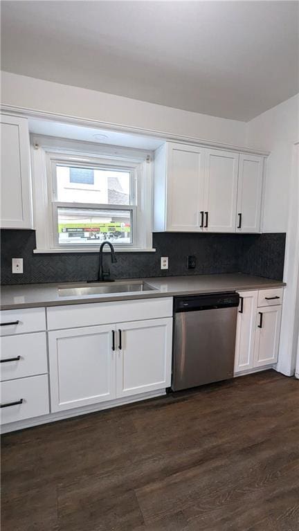 kitchen with white cabinetry, stainless steel dishwasher, dark wood-type flooring, and sink