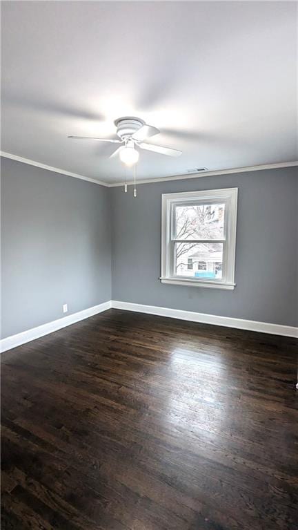 empty room featuring crown molding, ceiling fan, and dark wood-type flooring