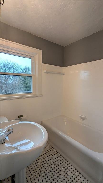 bathroom featuring sink, tile patterned floors, and shower / bath combination