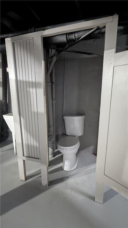 bathroom featuring concrete floors and toilet