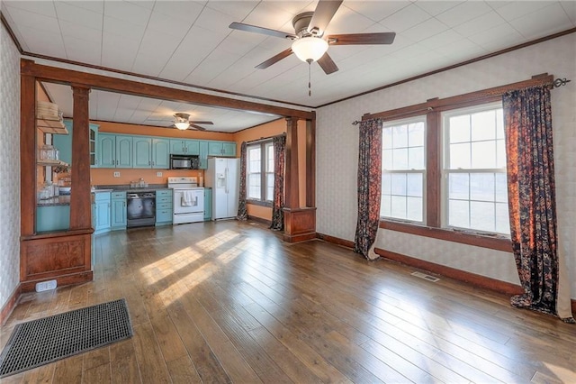 unfurnished living room featuring dark wood-type flooring, ornamental molding, and ceiling fan