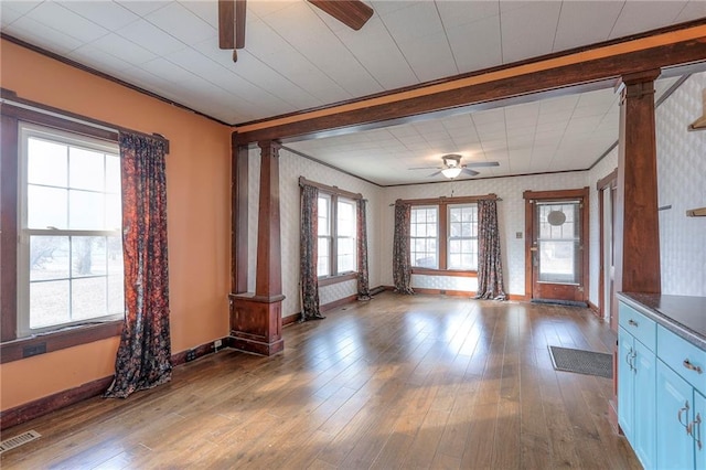 interior space featuring ceiling fan, ornamental molding, light hardwood / wood-style floors, and decorative columns