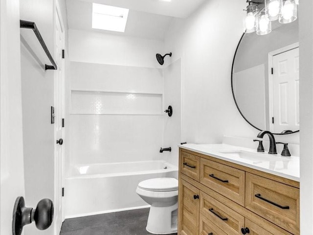 full bathroom featuring washtub / shower combination, vanity, and toilet