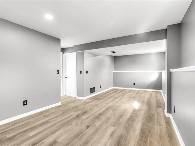 basement with light hardwood / wood-style floors