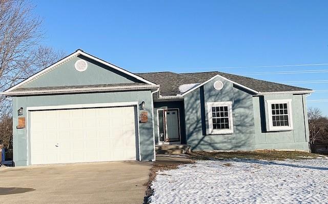 ranch-style house with driveway and an attached garage