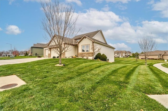 view of front of property featuring a garage and a front yard