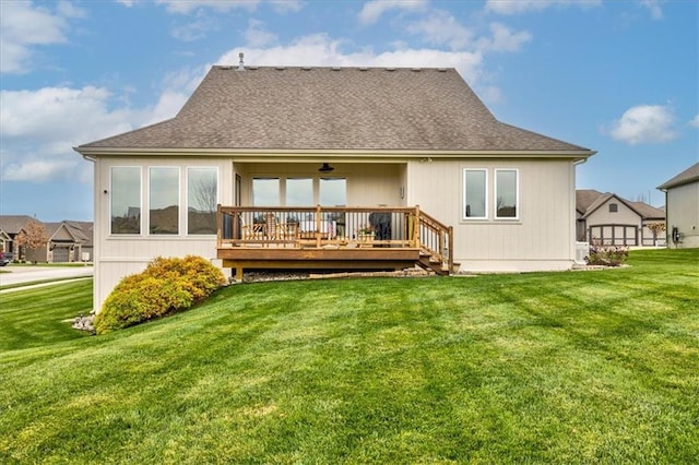 back of property featuring a wooden deck and a yard