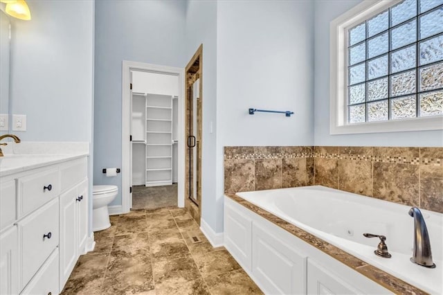 full bathroom featuring independent shower and bath, vanity, and toilet