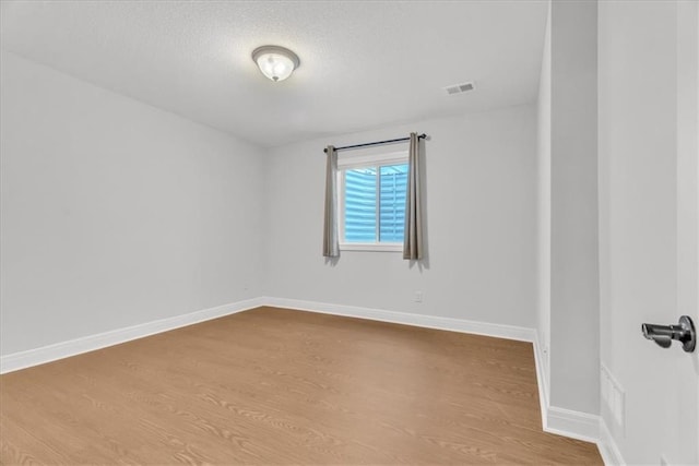 spare room featuring light hardwood / wood-style floors