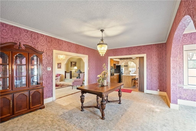 office featuring wallpapered walls, arched walkways, a textured ceiling, carpet floors, and a chandelier