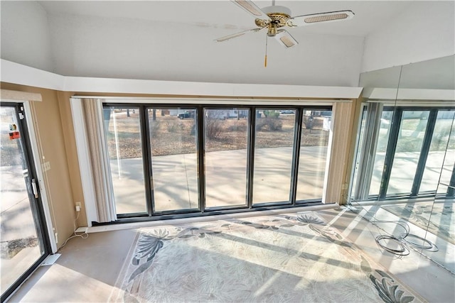 unfurnished sunroom featuring ceiling fan