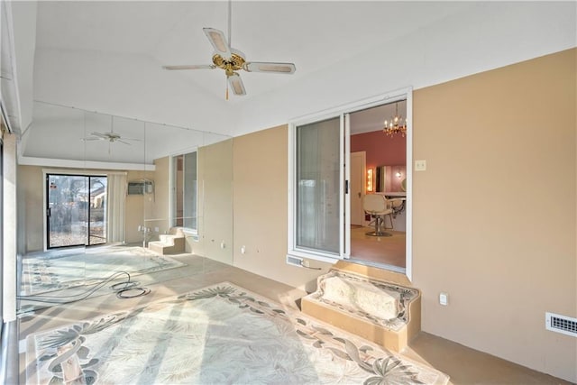 interior space with ceiling fan with notable chandelier and vaulted ceiling