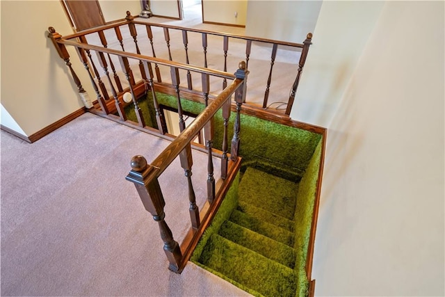 stairs featuring carpet floors and baseboards