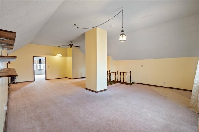 bonus room with vaulted ceiling, a textured ceiling, carpet flooring, and baseboards