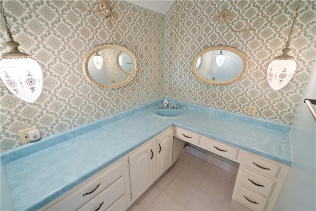 bathroom with wallpapered walls, tile patterned floors, and vanity