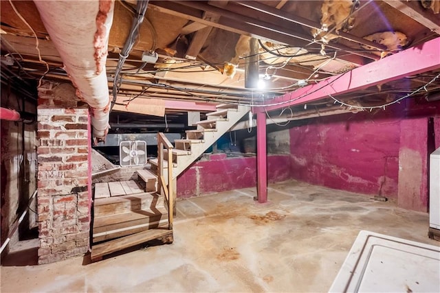 unfinished basement featuring washer / dryer