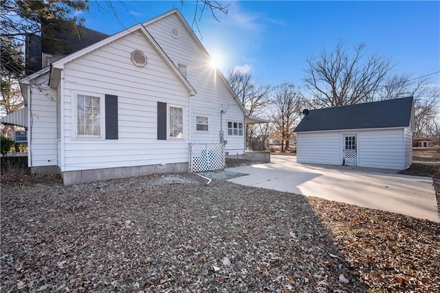 rear view of house with an outbuilding and a patio area