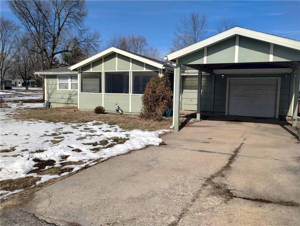 ranch-style home with a carport and a garage