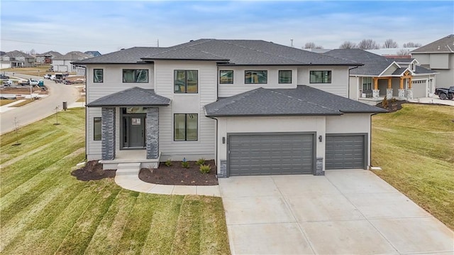 prairie-style home with a garage, driveway, roof with shingles, a residential view, and a front yard