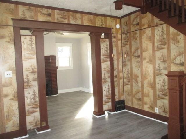 interior space featuring dark wood-type flooring and ornate columns