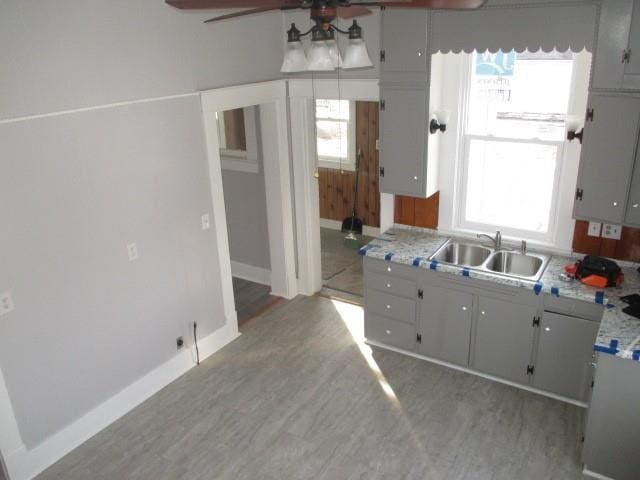 kitchen with sink, a wealth of natural light, and ceiling fan